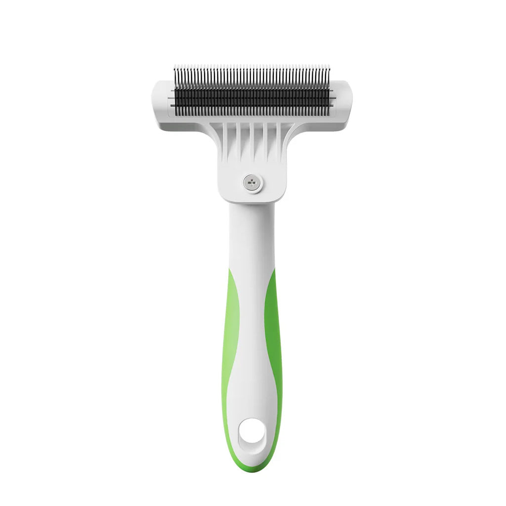 Pet grooming brush with green handle on a white background