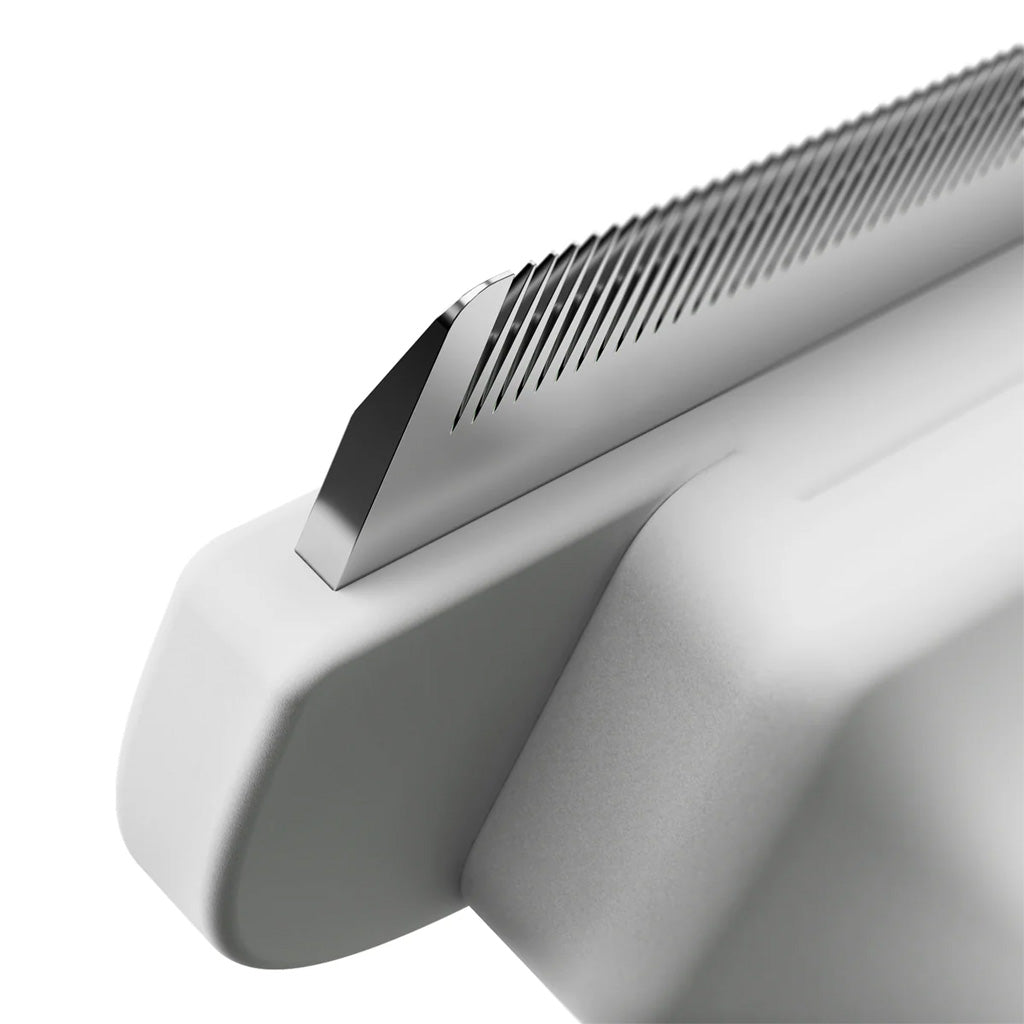 Close-up of a metallic object with a textured surface on a white background